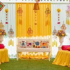 For this Mehendi, I used bright hues, printed cushions, and whimsical dreamcatchers to create a festive and colorful atmosphere that perfectly matched the couple's vibrant personalities.