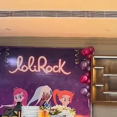 The backdrop for a 'Lolirock' themed birthday party, featuring the show's characters and logo. This sets the stage for a magical and enchanting celebration for the birthday girl.