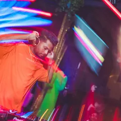 Listening closely to the next track in my headphones. A huge part of DJing is seamless transitioning and beat matching to keep the dance floor moving without interruption.