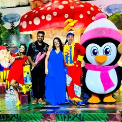 A colorful group photo featuring our Penguin mascot, a dwarf character, and a juggling clown posing with happy clients. We provide a variety hub of performers to enhance any day.