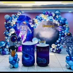 Blast off into fun with this cosmic space adventure I designed for Hitansh's fifth birthday. The decor features astronaut cutouts, galaxy-printed plinths, and a swirling balloon arch of blues and silvers to make the little astronaut's party feel like a trip around the moon.