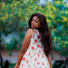 A simple floral dress in a sunlit park. This is the essence of a relaxed, natural light lifestyle session, perfect for capturing warm and joyful portraits.
