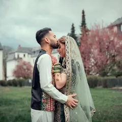 A tender forehead kiss during an outdoor wedding ceremony. This shot captures the love and commitment between the couple.
