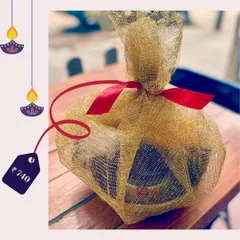 This Diwali, spread the love with a 'Pawsket' for your dog. This gift is wrapped in a beautiful golden net with a red ribbon, priced at just ₹740.