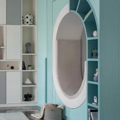 For this child's bedroom, we designed a world of imagination. The centerpiece is this cozy, circular reading nook built into the wall, surrounded by integrated shelving for books and treasures. It’s a functional and playful sanctuary for a child to read, dream, and grow.