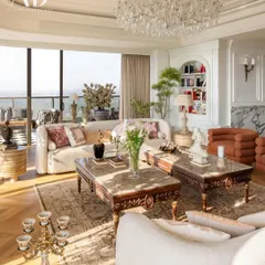 My approach to living spaces involves a rich layering of textures, patterns, and eras. Here, antique furniture, opulent sofas, and crystal chandeliers are juxtaposed with contemporary pieces, creating a room that feels like a lived-in celebration of personal history and timeless style.