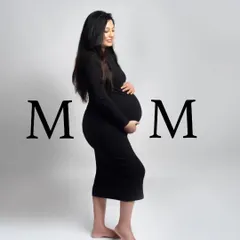 A simple and powerful solo portrait celebrating the mom-to-be. The clean background and classic black dress put all the focus on her and her beautiful baby bump.