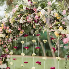A close-up of the Haldi floral arch. I love mixing different flowers and colors to create a rich texture, and the hanging carnation strings added such a delicate and pretty touch.