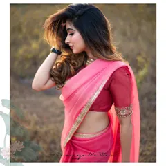 The saree is paired with a raw silk blouse with intricately embroidered sleeves, adding a touch of texture and opulence.