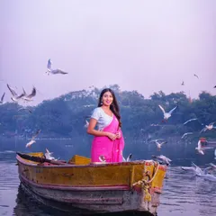 A serene portrait from the Yamuna Ghat series. The simple styling of the saree and minimal jewelry allows the natural beauty of the location and the subject to shine through, embodying an "old school" elegance.