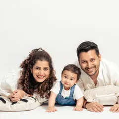 A classic family portrait against a clean white studio background. This setup is perfect for creating bright, high-energy photos that focus entirely on the family's happy expressions.