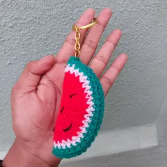 A juicy-looking crochet watermelon slice keychain. It's a fun and summery accessory for your keys or bag.