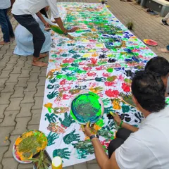 The process of creation. Participants work together on a massive canvas, using their own handprints to create a collaborative piece of art. It’s messy, joyful, and deeply communal.