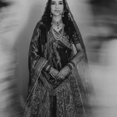 A powerful black and white bridal portrait with a motion blur effect, creating a dramatic and ethereal mood.