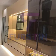 Here, the focus is on the tall unit with a smoked glass sliding door, which cleverly conceals appliances and storage. This feature helps maintain a clean, uncluttered look while keeping everything easily accessible.