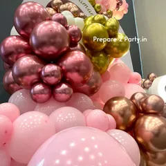 A close-up of the balloon artistry, showing the mix of chrome, metallic, and pastel balloons used in this premium birthday decoration. The quality and density of the garland create a lush, high-end feel.