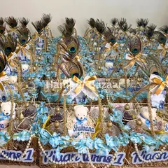 An army of love! We created these beautiful 'Shukrana' themed hampers for Kian's first birthday party, each one decorated with peacock feathers, a little teddy bear, and personalized tags.
