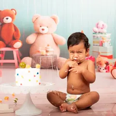 The moment the mess begins. This candid shot captures the baby's reaction to his first taste of birthday cake, a memory the parents will cherish and laugh about for years.