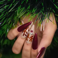 A side profile of the festive reindeer nail art. This view shows the smooth application and glossy finish of the polish, along with the cute, detailed face of the reindeer design.