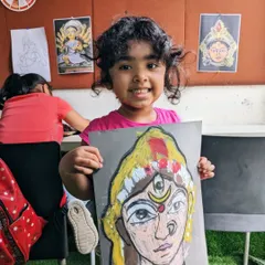The final result of hard work and creativity. This young artist created a bold and expressive goddess portrait using oil pastels on dark paper.