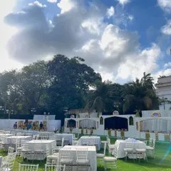 The expansive lawn set up for a large wedding, with my team ensuring every detail is perfect before guests arrive.