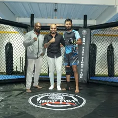 Me with our announcer and one of our top fighters inside the cage. Our facility is a hub for the local MMA community.