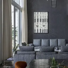 The main living area features a striking black textured wall that provides a dramatic backdrop for the contemporary art and minimalist furniture. The open-plan layout connects the living and dining areas, flowing out to an open-to-sky balcony.