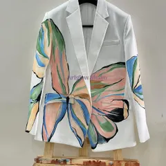 This white blazer features a large, abstract floral design in a soft pastel palette. The artwork flows across the front and onto the sleeves, creating a bold yet elegant statement piece.