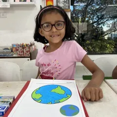 A happy student from one of our regular kids' art classes proudly displays her drawing of the Earth. Our classes focus on building fundamental skills in a relaxed, encouraging setting where every child can feel like a successful artist.