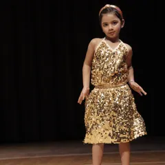 One of our 'Little Champs' in her beautiful golden costume, ready for her performance at THIRKAN. We focus on building stage confidence from a young age.