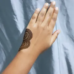 The start of a bold henna tutorial, showing the first section of a large, graphic design.