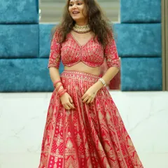 This happy customer is twirling in one of my favorite Banarasi lehengas. The rich red fabric and traditional gold patterns make it a timeless choice for a bride.