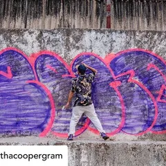 A classic bubble letter 'throw-up' in progress. This large-scale piece was painted on a rough concrete wall in Mumbai, using bold pink outlines to make the purple fill pop. This style is meant to be done fast and make a big impact.