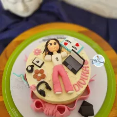 This cake is a perfect match for the birthday girl's hobbies. I created fondant versions of her laptop, headphones, cookies, and even a little book to capture her personality in edible form.