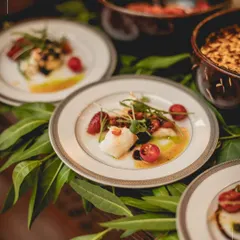 A plate of Burrata di Puglia, where creamy cheese meets the subtle sweetness of chilli jam and fresh basil pesto. This dish represents our philosophy: honouring classic ingredients with a contemporary, artful touch for a refined culinary experience.