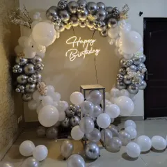 An indoor version of the silver and white balloon ring. This setup is perfect for creating a photo backdrop inside your home or at a venue.