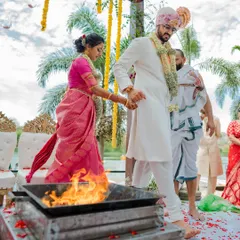 A vibrant varmaala ceremony with colorful smoke, creating a truly spectacular and modern moment. We love capturing both the tradition and the unique personality of your wedding.