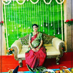 A mother-to-be seated during her Seemantham ceremony. The backdrop is made of fresh banana leaves and decorated with hanging jasmine flowers for a traditional South Indian feel.