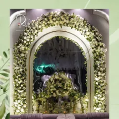 An enchanted forest theme brought to life with a magnificent arch of white roses. This created a breathtaking focal point for a seating area, making guests feel like they've stepped into a fairytale.