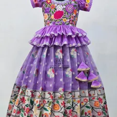 An exquisite lavender lehenga with a floral Paithani-style border. The outfit is elevated by a ruffled, tiered peplum top and a blouse with heavy multi-color floral embroidery.
