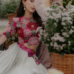 A dreamy, Pinterest-worthy shot from a Mehendi ceremony. The bride, surrounded by fields of flowers, looks like she's stepped out of a fairytale. The floral blouse and soft colors add to the romantic, bohemian vibe.