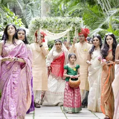 The bride's grand entrance under a 'phoolon ki chadar' held by her family. A beautiful, traditional moment full of emotion and support.