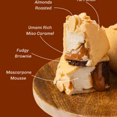This is a look inside our Miso Caramel Tart. It features a unique combination of a fudgy brownie base, mascarpone mousse, and an umami-rich miso caramel, all encased in a crisp tart shell. It’s one of our more adventurous gourmet desserts.