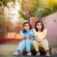 We loved this outdoor session with twin sisters. Their matching outfits and serious expressions, combined with the beautiful backlighting and natural setting, created a truly striking and memorable portrait.