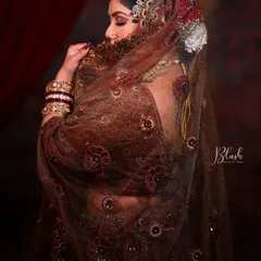 The beauty is in the details. This shot captures the delicate work on the eyes and the way the makeup complements the intricate details of the bridal dupatta, creating a cohesive and elegant look for a traditional bride.