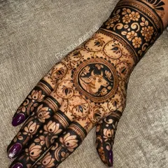 This design features a central mandala with a holy cow, a sacred symbol in Hinduism. The hand is covered in a pattern of blooming lotuses, creating a design that is both spiritual and aesthetically beautiful.