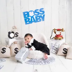Here's my take on the popular 'Boss Baby' theme. This little one is styled in a mini suit, looking cool and in charge, surrounded by fun props like a vintage phone and money bags.