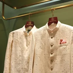 A classic pairing for any celebration. This look features a textured ivory bandhgala jacket with subtle embellishments and a fine kurta, showcasing our dedication to clean lines and understated elegance in groomswear.