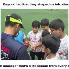 A coach giving a team talk to a group of young players. Beyond tactics, our coaches shape disciplined players and better human beings.