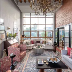 For a contemporary home in Dhaka, we created a space that felt both grand and intimate. The double-height windows flood the room with light, illuminating the blend of modern furniture and traditional textures, like the exposed brick wall and handwoven rug. It’s a space designed for conversations, where the old world and the new can meet.
